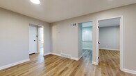 Located at 9506 W 87th St in Overland Park, Kansas, this thoughtfully updated 2-bedroom, 1-bathroom single-floor home offers a clean, modern aesthetic throughout. Warm-toned luxury vinyl plank flooring runs continuously across every room, creating a cohesive and low-maintenance living environment. Neutral gray walls and crisp white trim provide a fresh, move-in-ready backdrop throughout the space.

The living room serves as a welcoming entry point, featuring recessed lighting and a solid front door with modern black hardware. A connecting hallway links the living area to the rest of the home. The kitchen is a standout feature, showcasing white shaker-style cabinetry with black hardware, dark countertops, a stainless steel sink, and a full suite of stainless steel appliances including a refrigerator, electric range, and dishwasher. A window allows natural light to brighten the space.

The spacious primary bedroom offers generous room to furnish comfortably, with access to a closet and views into the hallway. The second bedroom is well-proportioned with ample natural light. The bathroom is cleanly finished with a white vanity, quartz-style countertop, black fixtures, and a tub-shower combination with a privacy window. This home presents a polished, updated interior well-suited for comfortable everyday living.