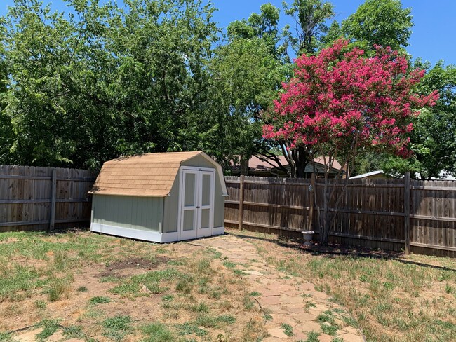 Backyard with Flagstone Patio and Storage Shed - 516 Mustang Drive