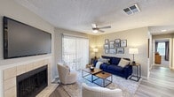 Located in Memphis, TN, this well-appointed 3-bedroom, 2-bathroom residence offers a thoughtfully designed single-floor layout. The inviting living room serves as the heart of the home, featuring a tile-surround fireplace, hardwood-style flooring, a ceiling fan, and a sliding glass door that opens to a private balcony with outdoor seating — filling the space with natural light. The galley-style kitchen is outfitted with white shaker cabinetry, granite-style countertops, subway tile backsplash, stainless steel appliances, and light wood-look flooring, providing both style and functionality. The primary bedroom offers comfortable carpeted flooring, a ceiling fan, a barn-style sliding door, and direct access to a private exterior door. A spacious walk-in closet with built-in wire shelving and hanging rods provides generous storage. The second bedroom is cozy and well-lit with neutral tones and plush carpeting. Both bathrooms are finished with white vanity cabinetry and granite-style countertops; one features a shower/tub combo. Neutral gray walls and consistent finishes throughout create a cohesive, modern aesthetic across this comfortable Memphis home.