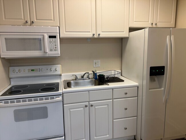 Cocina blanca nueva con refrigerador grande, estufa y microondas. - 630 NW 7th Ave
