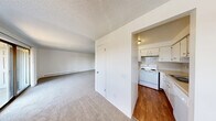 This 2-bedroom, 1-bathroom unit at Park Ridge in Bremerton, WA offers a comfortable and functional single-floor layout. The living room is generously proportioned, featuring soft carpeting, a textured ceiling, baseboard heating, and a sliding glass door that opens to a private balcony with views of the surrounding greenery. Natural light filters in through multiple windows, creating a bright and welcoming atmosphere throughout.

The kitchen is efficiently laid out with warm hardwood-style flooring, white cabinetry, a tiled backsplash, and white appliances including a refrigerator, electric range, and dishwasher. A double-basin sink completes the functional workspace.

Both bedrooms are carpeted and well-lit by natural light from windows overlooking the outdoors. Each room includes baseboard heating and generous closet space — the unit features four closets in total, providing excellent storage throughout. The primary bedroom is a comfortable size, with direct access to the balcony via a sliding glass door.

The full bathroom includes a combined tub and shower with clean, white surroundings. The unit's neutral white walls, consistent flooring choices, and practical layout make it a versatile and move-in-ready home in the heart of Bremerton, WA.