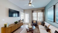 Located at Bay Island Lane in Kissimmee, Florida, this thoughtfully designed 2-bedroom, 2-bathroom residence offers a comfortable and contemporary living experience across a single floor. Light wood flooring runs throughout, creating a warm, cohesive aesthetic from room to room.

The open-concept kitchen is a standout feature, showcasing white shaker cabinetry, a subway tile backsplash, stainless steel appliances, and a large center island with a pristine white countertop and bar seating — ideal for casual dining or entertaining. Pendant lighting adds a refined touch overhead.

The living room is bright and welcoming, with large windows fitted with plantation shutters that invite natural light while offering privacy. A ceiling fan, neutral tones, and access to an outdoor balcony enhance the room's airy feel.

The primary bedroom features soft sage-green accent walls, wood flooring, and a dedicated walk-in closet. The second bedroom mirrors this comfortable style with calming blue-gray tones and ample natural light. Each bedroom is paired with its own full bathroom — one with a long vanity and glass-enclosed shower, and the other conveniently accessible directly from the bedroom.

Two dedicated closets provide generous storage throughout this well-organized and stylishly finished Kissimmee residence.