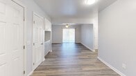 Located at 109 Club Dr in Morganton, NC, this single-story, 3-bedroom, 2-bathroom home offers a clean, modern aesthetic throughout. The interior is unified by durable wood-look plank flooring and a soft neutral color palette that creates a bright and welcoming atmosphere.

The open living area is anchored by a ceiling fan and a large sliding glass door that fills the space with natural light. The kitchen is thoughtfully appointed with gray shaker-style cabinetry, a subway tile backsplash, white countertops, and black appliances, including a range, over-the-range microwave, and refrigerator.

The primary bedroom provides a comfortable retreat with its own walk-in closet featuring wire shelving and access to a dedicated bathroom. The additional bedrooms are well-proportioned, each featuring the same wood-look flooring and windows with blinds that allow for natural light and privacy. A hallway connects the bedroom wing to the main living spaces.

Both bathrooms are finished consistently, featuring gray vanity cabinetry, white countertops, framed mirrors, and lighted vanity fixtures. The overall layout is efficient and functional, maximizing the use of available space. This home presents a move-in-ready option with updated finishes throughout.