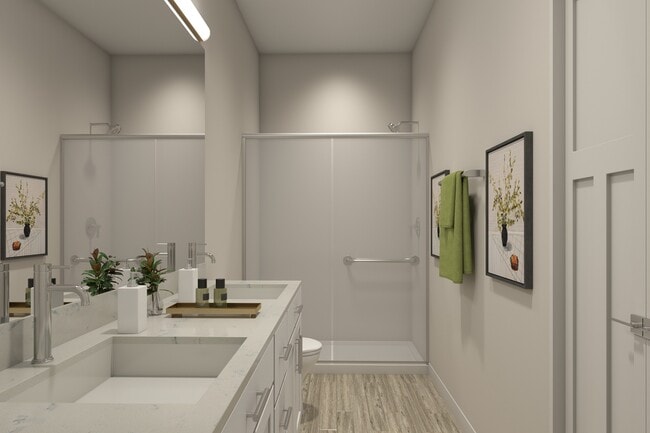 Flats at Sugar Run Delaware Ohio apartments showing a bathroom with dual sink and walk-in shower. - Flats at Sugar Run