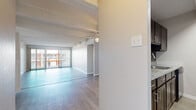 Located at 8000 E Girard Ave in Denver, CO, this well-appointed 2-bedroom, 2-bathroom residence offers a functional and comfortable single-floor layout. The living room is an open, airy space highlighted by distinctive exposed beam ceilings, light hardwood-style flooring, and a ceiling fan. Sliding glass doors with vertical blinds lead to a balcony, allowing natural light to fill the room. The galley-style kitchen features dark espresso cabinetry, gray tile backsplash, stone-look countertops, and black appliances, providing a sleek, efficient workspace. Both bedrooms are carpeted and feature the same characteristic exposed beam ceilings. The generously sized primary bedroom includes dual built-in closets with bifold doors offering ample storage. The second bedroom is well-proportioned with a large window that brings in natural outdoor views. Each bathroom is clean and functional — one features a full soaking tub with white tile surround, while the other includes a wide vanity with stone-look countertops, white cabinetry, a large mirror, and wood-style flooring. Hallways connect the rooms efficiently, completing this practical and comfortable Denver home.