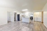 Located on W University Ave in Gainesville, FL, this single-floor, 3-bedroom, 2-bathroom home offers a practical and comfortable layout. The open-concept living and kitchen area is bright and welcoming, featuring light wood-style flooring throughout. The kitchen is well-equipped with white shaker-style cabinetry, light countertops, stainless steel appliances including a refrigerator, range, and dishwasher, and a central island that adds prep space and a natural gathering point. A dedicated in-unit laundry area with a washer and dryer is conveniently accessible from the kitchen. The living room offers a windowed front entrance and an open feel with a textured ceiling. Each of the three bedrooms is carpeted for comfort and includes a ceiling fan, a window for natural light, and individual closets — some featuring built-in shelving. The primary bedroom is generously proportioned with ample closet space. The two bathrooms are finished with wood-style flooring, white vanities with light countertops, and clean, neutral tones. One bathroom includes a full tub/shower combo, while the other serves as a half bath. With four closets total and an efficient floor plan, this home maximizes every square foot of its well-organized single-level layout.