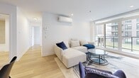 Located at 550 Avenue Delmar in Pointe-Claire, this well-appointed 3-bedroom, 2-bathroom unit offers a thoughtfully designed open-concept layout with contemporary finishes throughout. Light hardwood flooring flows seamlessly across the entire space, enhancing its bright and airy feel.

The living and dining area forms the heart of the unit, bathed in natural light from large floor-to-ceiling windows that offer views of the surrounding neighbourhood. A split-unit air conditioning system ensures year-round comfort. The modern kitchen features two-toned cabinetry — sleek white upper cabinets paired with warm wood-grain lower units — complemented by a stainless steel range with a wall-mounted hood, a generous island with breakfast bar seating, and a neutral tile backsplash.

The spacious primary bedroom provides a generous and serene retreat, while the two additional bedrooms each benefit from large windows and ample natural light. Both bathrooms are finished with clean, modern tile work; one includes a glass-enclosed walk-in shower, while the second features a full soaking tub. A stacked washer and dryer unit is conveniently integrated within the second bathroom. A dedicated closet adds practical storage to complete this functional and stylish home.