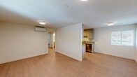 Located at 968 West 7th Street in Upland, California, this single-story 2-bedroom, 1-bathroom home offers a clean, modern aesthetic throughout its well-organized floor plan. Light wood-style flooring runs continuously across all rooms, creating a cohesive and bright feel. The open living, dining, and kitchen area forms the heart of the home, where a half-wall partition subtly defines the kitchen from the living space. The kitchen is thoughtfully designed with light wood cabinetry extending to the ceiling, quartz-style countertops, a stainless steel sink, dishwasher, range, microwave, and refrigerator — providing generous storage and functionality. Ductless mini-split units in the main living area and bedrooms ensure efficient, individual climate control. Both bedrooms are well-proportioned with large windows dressed in white blinds that invite natural light. The primary bedroom features a dedicated walk-in closet with built-in shelving and hanging rods. The shared bathroom includes a quartz-top vanity, toilet, and a tub-shower combination. Additional spaces include a laundry area, utility room, and multiple closets, rounding out a practical and move-in-ready home.