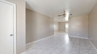 Located at 5900 Bissonnet St in Houston, TX, this single-story, two-bedroom, one-bathroom home offers a practical and well-laid-out floor plan. The living area features large marble-look porcelain tile flooring that extends throughout the main living spaces, lending a clean and modern aesthetic. A ceiling fan with a light fixture keeps the space comfortable and well-lit. The open sightline from the living area leads toward the front entry, where natural light filters in through a window near the door.

The galley-style kitchen is equipped with gray cabinetry, light granite-style countertops, a double stainless steel sink, and a stainless steel range. Two windows allow ample natural light into the kitchen. A pass-through counter connects the kitchen to the adjacent living area, enhancing the open feel of the home.

Both bedrooms are carpeted and feature ceiling fans, neutral-toned walls, and windows that bring in natural light. The primary bedroom is generously sized and includes two closets. The second bedroom also offers closet access and dual windows. The bathroom includes a full soaking tub with white tile surround and granite-style vanity countertops. A hallway connects the main living spaces to the bedrooms and bathroom, completing the functional layout of this Houston home.