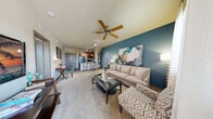 Located at 4652 Miramar Dr in St. Petersburg, Florida, this single-floor, one-bedroom, one-bathroom residence offers a thoughtfully designed layout with a cohesive, modern aesthetic throughout. The open living area is highlighted by a distinctive teal accent wall, plush carpeting, a ceiling fan, and large windows with blinds that invite natural light. A private entry door adds convenience and security directly from the living space.

The kitchen is a standout feature, showcasing warm wood cabinetry, granite countertops, a peninsula island with bar seating, pendant lighting, track lighting, hardwood-style flooring, and black appliances including a refrigerator, electric range, and microwave. An arched architectural detail adds a classic touch connecting the kitchen to the hallway.

The bedroom continues the teal accent wall theme, offering plush carpeting, natural light from a window with blinds, and direct access to a walk-in closet and bathroom. Two closets provide ample storage throughout the unit.

The bathroom features tile flooring, a single vanity with wood cabinetry and stone-look countertops, a large mirror, and a full soaking tub with a shower combination. The hallway connects all rooms efficiently, completing the well-organized floor plan of this comfortable St. Petersburg residence.