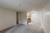 Located on East Middlefield Road in Sunnyvale, California, this single-floor, two-bedroom, two-bathroom residence offers a practical and well-organized layout. The living room is a comfortable, carpeted space anchored by a sliding glass door that opens to a patio, allowing natural light to filter in alongside views of surrounding greenery. A ceiling fan overhead adds to the functional design of the adjoining area.

The galley-style kitchen is efficiently arranged with warm wood cabinetry lining both sides, dark granite-style countertops, hardwood-style flooring, and stainless steel appliances including a range, microwave, refrigerator, and dishwasher. Ample upper and lower cabinet storage makes the kitchen highly practical.

The primary bedroom is a well-proportioned, carpeted room featuring a window with outdoor views and a closet with built-in shelving. The second bedroom is similarly carpeted with its own closet. Both bathrooms include a vanity with dark countertops, wood cabinetry, and a combined tub and shower. A dedicated laundry area with wire shelving provides additional storage. Throughout, neutral tones and clean finishes create a cohesive, understated ambiance.