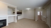 Located at 8121 W Eastman Pl in Lakewood, Colorado, this single-floor residence offers a well-organized, open-concept layout designed for comfortable living. The main living and dining area is generously proportioned, featuring plush neutral carpeting, crown molding, and decorative columns that define the space without obstructing sightlines. The kitchen is positioned adjacent to the living area and is equipped with rich dark-stained cabinetry, stainless steel appliances including a smooth-top range and over-the-range microwave, a classic white subway tile backsplash, and a peninsula counter that provides a natural separation between the kitchen and living space.

The bedrooms are carpeted and well-lit, each featuring ceiling fans and windows with blinds that allow for natural light. One bedroom benefits from vaulted ceilings, adding a sense of openness, while another includes a closet with bifold doors and built-in shelving. A spacious walk-in closet with wire shelving on multiple walls offers notable storage capacity.

The bathrooms are finished with wood-look tile flooring, dark-stained vanities, white countertops, large framed mirrors, and a tub-shower combination accented with white tile surrounds. The overall aesthetic throughout is cohesive, clean, and neutral.
