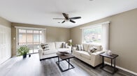 Located at 1005 McCord Rd in Valparaiso, Indiana, this single-floor unit offers a well-organized layout designed for comfortable everyday living. The living room serves as the heart of the space, featuring warm neutral-toned walls, durable wood-look flooring, and a ceiling fan overhead. Large windows and a sliding glass door leading to an outdoor deck flood the room with natural light and provide views of the surrounding greenery, creating an open and welcoming atmosphere. Two plush sofas and a dark-toned coffee table complete the space.

The kitchen is efficiently designed with crisp white cabinetry, light countertops, and a full suite of stainless steel appliances including a gas range, built-in microwave, and dishwasher. A single-basin sink with a modern faucet adds a clean, functional touch, and the light wood-look flooring carries throughout.

The bedroom is a calm retreat, featuring a ceiling fan, a double closet with paneled doors, and windows that invite natural light. The warm taupe walls and wood-look flooring create a cohesive, restful environment.

The bathroom is finished with a white vanity, clean countertop, and a shower/tub combination with a classic striped curtain, all set on matching wood-look flooring for a consistent aesthetic throughout the unit.