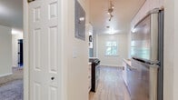 This single-floor residence offers a clean, modern aesthetic throughout, with a thoughtful layout that maximizes functionality. The galley-style kitchen is a standout feature, outfitted with white shaker cabinetry, granite-look countertops, and a full suite of stainless steel appliances including a gas range, dishwasher, microwave, and refrigerator. Light wood-look flooring runs through the kitchen and utility areas, adding warmth and easy maintenance.

The open living and dining areas are finished with plush wall-to-wall carpeting and neutral-toned walls, creating a bright and versatile space. Natural light filters in through multiple windows, enhancing the airy feel. A sliding glass door provides additional light and outdoor access from the living area.

The bedroom is generously sized with soft carpeting, a window with natural light, and convenient access to an in-unit laundry closet equipped with a washer and dryer. The bathroom features a full tub-shower combo with chrome fixtures, a white vanity with storage, and wood-look flooring that ties the space together cohesively.

Overall, this residence combines practical design with updated finishes, offering a comfortable and move-in-ready living environment with well-organized spaces throughout.