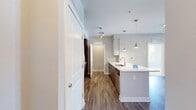 Step into a world of contemporary elegance and effortless living. This stunning 840 sq ft apartment boasts an open-concept kitchen and living area, perfect for entertaining or relaxing after a long day. The sleek kitchen features stainless steel appliances, quartz countertops, and ample storage, inspiring your inner chef. Large windows flood the space with natural light, creating an airy ambiance and offering picturesque views of the surrounding area. The primary bedroom, a generous 150 sq ft retreat, provides a serene sanctuary for rest and rejuvenation. Two well-appointed bathrooms offer modern fixtures and finishes, while the in-unit laundry adds convenience to your daily routine. Rich hardwood floors throughout and plush carpeting in the bedrooms blend comfort with sophistication. This meticulously designed home embodies urban chic, offering a lifestyle of ease and luxury in the heart of the city.