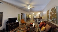 Located at 2204 SE Augusta Blvd in Bentonville, Arkansas, this single-story home offers four bedrooms and two bathrooms within a well-utilized floor plan. The open-concept living and dining area serves as the heart of the home, featuring plush carpeting, a textured ceiling, and a ceiling fan overhead. Natural light filters in through multiple windows, creating a bright and welcoming atmosphere. The living room flows seamlessly into the kitchen and dining space, making it ideal for everyday living and entertaining.

The kitchen is equipped with white cabinetry, a full-size refrigerator, built-in microwave, and a breakfast bar with seating. Tile flooring runs through the kitchen and dining area, while a convenient in-unit laundry closet with a washer is tucked just off the kitchen. A ceiling fan adds comfort to this combined space.

The bedrooms are carpeted and comfortably sized, with the primary bedroom offering a walk-in closet and its own ceiling fan. The two bathrooms each feature a tub-shower combination with sliding glass doors, tile flooring, and ample cabinet storage above. A hallway connects the private quarters to the main living areas, completing this functional and practical single-floor layout.