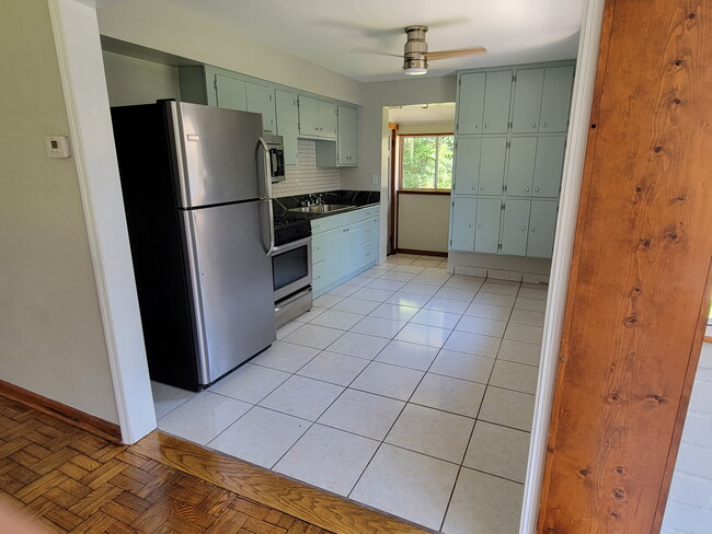 Lots of storage granite countertops and subway tiled backsplash - 3310 NW 4th St