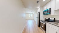 Located on Weddington Street in the Sherman Oaks neighborhood of Los Angeles, this thoughtfully designed 2-bedroom, 1-bathroom unit offers a clean, contemporary aesthetic throughout its single-floor layout. Light-toned hardwood flooring runs seamlessly through every room, creating a warm and cohesive feel.

The open living area is bright and welcoming, with recessed lighting and a large window framing views of the surrounding Los Angeles landscape, including the iconic palm trees characteristic of the area. The space flows directly into the galley-style kitchen, which features white shaker cabinetry, dark countertops, stainless steel appliances including a range, refrigerator, and dishwasher, and a double-basin sink — a functional and stylish setup for everyday living.

Both bedrooms are comfortably sized with large black-framed windows that invite abundant natural light and outdoor greenery views. The rooms feature clean white walls and recessed lighting, offering a neutral canvas for personalization. A dedicated closet provides additional storage.

The bathroom is well-appointed with a sliding-glass enclosed tub and shower combo, a white vanity with dark countertop, built-in open shelving, and wood-look flooring that ties the space together. The unit's modern finishes and efficient layout make it a practical and attractive residence.