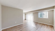 Located at 537 Tranquil Ct in Odenton, Maryland, this one-bedroom, one-bathroom residence offers a well-organized single-floor layout filled with natural light. The living room is expansive and airy, finished with warm wood-tone flooring and neutral wall tones that create a clean, inviting atmosphere. Large sliding glass doors open to a private balcony, while an additional window allows sunlight to stream across the space throughout the day. The kitchen is thoughtfully designed with white cabinetry, a classic subway tile backsplash, granite-style countertops, and a full suite of stainless steel appliances including a refrigerator, gas range, built-in microwave, and dishwasher. A peninsula countertop provides additional prep space and a natural transition into the living area. The bedroom is generously sized, featuring plush carpeting, a large window with natural views, and access to a dedicated closet. The bathroom includes a full-size soaking tub and shower combination with clean white finishes. Throughout the home, consistent neutral tones, wood-look flooring in the main areas, and an abundance of natural light contribute to a bright, comfortable, and move-in-ready living environment.