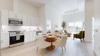 Located in Kanata, Ottawa, this thoughtfully designed 2-bedroom, 2-bathroom unit offers a bright, open-concept living space enhanced by soaring ceilings and light-toned wide-plank flooring throughout. The kitchen is outfitted with crisp white shaker cabinetry accented by gold hardware, marble-style quartz countertops and backsplash, and a full suite of stainless steel appliances. The dining area flows seamlessly into the living room, where expansive floor-to-ceiling windows and a sliding glass door flood the space with natural light and provide access to a private balcony with open views. The primary bedroom is a well-proportioned retreat featuring a large window with treetop views and ample natural light. The second bedroom is equally bright and serene. Both bathrooms are finished with marble-effect tile surrounds — the ensuite boasting a glass-enclosed walk-in shower, while the second bathroom features a full soaker tub. The consistent use of warm whites, soft neutrals, and refined gold accents lends a cohesive, contemporary elegance to the entire unit, creating a calm and inviting atmosphere throughout.