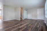 Located at 1029 W Badger Rd in Madison, Wisconsin, this three-bedroom, three-bathroom home spans three floors, offering a practical and well-organized layout across a generous total footprint. The main level features rich, dark hardwood-style flooring throughout open living areas filled with natural light from multiple windows. A staircase connects the levels seamlessly, with clean white trim and neutral gray walls lending a fresh, cohesive aesthetic throughout.

The combined kitchen and dining area is appointed with white shaker-style cabinetry, stone-look countertops, and stainless steel appliances, including a full-size refrigerator and range. A second living room provides additional flexible living space. The bathrooms are cleanly finished with white vanities and mirrored medicine cabinets.

The upper floor houses the bedrooms, including a spacious primary bedroom. Bedrooms feature a mix of hardwood and light wood flooring, ceiling fans, and natural light from windows overlooking the surroundings. Multiple closets throughout the home provide ample storage.

The basement level offers several unfinished rooms with painted concrete floors and exposed ceiling joists, ideal for storage or utility use, and includes a dedicated utility room. With five closets and three staircases connecting all levels, this home provides functional versatility throughout.