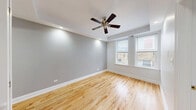 Located at 1200 West Pratt Boulevard in Chicago's vibrant Rogers Park neighborhood, this well-appointed one-bedroom, one-bathroom unit offers a thoughtful and efficient layout. Light-toned hardwood floors run throughout, lending warmth and continuity to every room.

The combined dining and living area provides a welcoming, open feel, enhanced by natural light streaming through windows that offer views of the surrounding neighborhood. A ceiling fan adds comfort and character to the space.

The kitchen is well-equipped with warm wood cabinetry extending to the upper walls for generous storage, dark granite countertops, and stainless steel appliances including a gas range, refrigerator, and built-in microwave.

The bedroom is a quiet, cozy retreat featuring a window with natural light, soft gray walls, and hardwood flooring. Two closets provide ample storage throughout the unit.

The bathroom is finished with neutral tile throughout, including a full soaking tub with shower, a white vanity with storage, and a lighted medicine cabinet mirror.

A dedicated laundry area with a stacked washer and dryer unit adds everyday convenience, while an accessible electrical panel and utility room complete the functional layout of this compact yet comfortable Chicago home.
