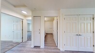 Located at 4800 B St in Springfield, Oregon, this two-bedroom, two-bathroom residence offers a well-designed single-level layout with a clean, modern aesthetic. The combined kitchen and living area serves as the heart of the home, featuring light luxury vinyl plank flooring, crisp white walls, and abundant natural light. The kitchen is equipped with white shaker-style cabinetry, granite-look countertops, and black Whirlpool appliances including a refrigerator, electric range, and dishwasher. A private covered balcony is accessible directly from the main living area, offering pleasant views of the surrounding tree-lined neighborhood. The primary bedroom is a generously sized retreat with plush carpeting, a large closet with sliding doors, and a dedicated en-suite bathroom. The en-suite features wood-look LVP flooring, a granite-topped vanity with white cabinetry, a walk-in shower, and accessibility-friendly grab bars. The second bedroom is similarly carpeted with a large window that fills the room with natural light. The second bathroom mirrors the first in its clean, functional design. Both bathrooms include modern fixtures and ample storage. Wall-mounted HVAC units are present in key rooms, ensuring year-round comfort throughout this well-appointed Springfield residence.