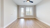 This 720-square-foot, one-bedroom, one-bathroom apartment is located at 2307 N Tryon St in Charlotte, North Carolina. The single-story unit is thoughtfully designed to maximize its compact footprint, offering a seamless open-concept layout that combines the kitchen and living room into one cohesive space. Light-toned, hardwood-style flooring runs throughout, lending a clean, modern aesthetic that brightens the interior.

The living area is highlighted by a ceiling fan, which adds both functionality and a subtle design element. A glass-paneled door opens to a private balcony, allowing natural light to pour in while providing outdoor access and views of the surrounding area. Adjacent windows fitted with horizontal blinds offer additional light control and privacy.

The primary bedroom spans 170 square feet and is complemented by a dedicated closet, providing practical storage. The bathroom rounds out the unit's layout, while the overall neutral color palette of warm beige tones on the walls creates a welcoming, versatile ambiance. This unit offers a well-balanced combination of modern design and functional living in a compact, efficient space.