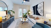 This thoughtfully laid-out one-bedroom, one-bathroom unit at 900 E Sligh Ave offers a cohesive modern aesthetic throughout its single-floor footprint. The open-concept kitchen is a standout feature, showcasing white shaker cabinetry, a subway tile backsplash, stainless steel appliances including a refrigerator with ice maker, electric range, microwave, and dishwasher, all complemented by light wood-look flooring. A freestanding kitchen island with seating provides additional prep and dining space.

The living room is bright and welcoming, featuring large windows with sheer curtains, a ceiling fan, and light-toned walls that enhance the sense of openness. The space flows naturally from the kitchen and entry area.

The primary bedroom offers carpeted flooring, a ceiling fan, and generous window placement that brings in natural light. It is served by a dedicated closet and connects to the full bathroom, which features a walk-in glass-enclosed shower with tile surround, a white vanity with under-mount sink, black hardware accents, and light wood-look flooring. The clean, neutral palette carries consistently throughout the unit, creating a modern and cohesive living environment.