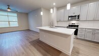 This contemporary apartment in Bel Air, MD, offers 1310 square feet of thoughtfully designed living space. The single-floor layout comprises three bedrooms, including a primary bedroom of 160 square feet, and three full bathrooms. The heart of the home is an open-concept kitchen and living area, featuring a gourmet kitchen with sleek white cabinetry, stainless steel appliances, and a large center island with pendant lighting. The kitchen's subway tile backsplash and quartz countertops add a touch of elegance.

Throughout the apartment, light oak-toned hardwood flooring creates a warm and inviting atmosphere. Large windows in the bedrooms and living areas allow for ample natural light, while ceiling fans provide additional comfort. The bathrooms are finished with modern fixtures, including floating vanities and tub-shower combinations with glass enclosures.

Storage is plentiful, with walk-in closets in the bedrooms and additional closet space throughout. The unit also includes in-unit laundry facilities. The neutral color palette and clean lines contribute to the apartment's modern aesthetic, providing a blank canvas for personalization. This well-appointed apartment offers a perfect blend of style and functionality for contemporary urban living.