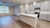 This contemporary apartment in Bel Air, MD, offers 1310 square feet of thoughtfully designed living space. The single-floor layout comprises three bedrooms, including a primary bedroom of 160 square feet, and three full bathrooms. The heart of the home is an open-concept kitchen and living area, featuring a gourmet kitchen with sleek white cabinetry, stainless steel appliances, and a large center island with pendant lighting. The kitchen's subway tile backsplash and quartz countertops add a touch of elegance.

Throughout the apartment, light oak-toned hardwood flooring creates a warm and inviting atmosphere. Large windows in the bedrooms and living areas allow for ample natural light, while ceiling fans provide additional comfort. The bathrooms are finished with modern fixtures, including floating vanities and tub-shower combinations with glass enclosures.

Storage is plentiful, with walk-in closets in the bedrooms and additional closet space throughout. The unit also includes in-unit laundry facilities. The neutral color palette and clean lines contribute to the apartment's modern aesthetic, providing a blank canvas for personalization. This well-appointed apartment offers a perfect blend of style and functionality for contemporary urban living.