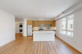 Located at 37 Orange Rd in Montclair, NJ, this thoughtfully designed 2-bedroom, 2-bathroom residence offers a bright, contemporary living experience across a single floor. Light wood flooring flows throughout, complementing the clean white walls and recessed lighting that give the space an airy, modern feel.

The open-concept kitchen and living area serves as the heart of the home. The kitchen is outfitted with warm natural wood cabinetry, crisp white quartz countertops, a glass tile backsplash, stainless steel appliances including a gas range, microwave, refrigerator, and dishwasher, and a central island that provides additional prep and dining space.

The two bedrooms are generously proportioned, each featuring large windows that invite abundant natural light and views of the surrounding Montclair streetscape. The primary bedroom includes a spacious walk-in closet with built-in shelving and hanging rods. Both bathrooms are finished in clean white tile, with one featuring a full soaking tub and shower combination.

A dedicated laundry area houses a stacked full-size washer and dryer unit, adding everyday convenience. The overall design aesthetic is clean, minimal, and move-in ready, making this residence a polished offering in a well-connected New Jersey location.
