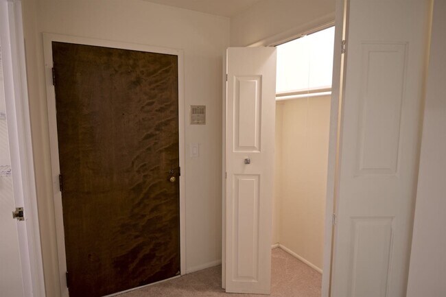 Entry door to the unit, with coat closet - 1250 Park Ave W