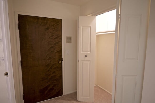 Entry door to the unit, with coat closet - 1250 Park Ave W