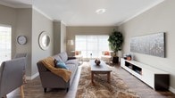 This single-story residence offers a cohesive neutral palette throughout, with warm taupe and gray tones creating a calm, modern ambiance. The living area is generously sized, featuring crown molding, wood-look flooring, and a large window dressed with white horizontal blinds that allows abundant natural light to fill the space. A separate sitting or flex room provides additional living space, finished with plush carpet and a ceiling fan overhead.

The kitchen is functionally designed with white cabinetry, dark granite-style countertops, a double sink, and a full suite of white appliances including a refrigerator, electric range, and built-in microwave. Wood-look flooring extends throughout the kitchen, adding durability and visual continuity.

The bedrooms feature carpet flooring and ceiling fans, with windows offering views to the exterior. One bedroom includes a walk-in closet, while another connects directly to a living area. Both bathrooms are well-appointed, each featuring a tub-shower combination, white cabinetry, dark granite-style countertops, a large vanity mirror, and wood-look flooring, providing a practical yet polished finish throughout.