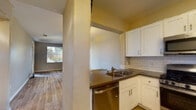 Located at 2290 Mackenzie Creek Rd in Chula Vista, California, this single-floor residence offers a well-organized layout with a seamless flow between living, dining, and kitchen spaces. The open-concept living and dining area features warm wood-look flooring, neutral wall tones, and a pendant light fixture that anchors the space. Natural light streams in through multiple windows fitted with blinds, creating a bright and welcoming atmosphere throughout.

The kitchen is thoughtfully designed with white shaker-style cabinetry, dark countertops, and a classic subway tile backsplash. A suite of stainless steel appliances — including a gas range, over-the-range microwave, and refrigerator — adds a modern, functional touch. A pass-through counter connects the kitchen to the living area, enhancing the open feel.

The bedrooms are carpeted and generously sized, each featuring neutral walls and windows that invite natural light. The primary bathroom includes a dual-sink vanity with white cabinetry, dark countertops, and wood-look flooring. A secondary bathroom provides a walk-in shower with safety grab bars, a toilet, and matching wood-look flooring, offering both comfort and accessibility. The overall design balances practicality with clean, contemporary finishes throughout.