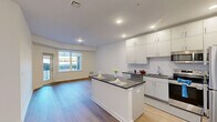Located at 37 N York Rd in Hatboro, PA, this well-appointed one-bedroom, one-bathroom unit offers a thoughtfully designed single-floor layout with modern finishes throughout. Light wood-tone flooring flows seamlessly across all rooms, creating a cohesive and airy atmosphere.

The open-concept kitchen and living area serves as the heart of the unit. The kitchen is outfitted with crisp white shaker-style cabinetry extending to the ceiling for ample storage, dark granite countertops, a classic white subway tile backsplash, stainless steel appliances, and a central island that provides additional prep space and a casual dining option. Recessed lighting illuminates the space effectively.

The living area benefits from large windows and a glass-panel door that opens to a private balcony, allowing abundant natural light and outdoor views of the surrounding neighborhood. A barn-style sliding door adds a contemporary design touch to the spacious primary bedroom, which also features clean white walls and continued wood-tone flooring.

The bathroom maintains the same refined aesthetic, featuring a granite-topped vanity with white cabinetry, a large mirror, and neutral tile flooring. A dedicated closet provides convenient storage. The unit also features a sliding barn door entry, adding character to the overall modern and clean design.