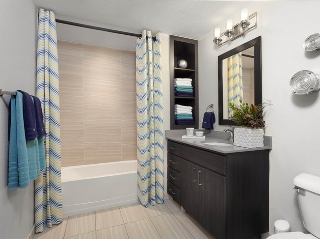 Spacious bathrooms with built-in shelves and framed mirrors - Studio LoHi Apartments