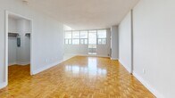 Located at 44 Cordova Ave in Toronto's sought-after Etobicoke neighbourhood, this well-appointed studio offers a thoughtfully designed single-floor layout. The open-concept kitchen and living area serves as the heart of the space, featuring warm parquet wood flooring in a classic herringbone pattern that extends throughout. Floor-to-ceiling windows flood the living area with natural light and provide sweeping outdoor views, creating a bright and airy ambiance. The kitchen is outfitted with clean white cabinetry, granite-accented countertops, white tile flooring, and a full-size Whirlpool refrigerator, offering a functional and tidy workspace. A private balcony accessible from the living area extends the space outdoors, ideal for enjoying city views. The spacious closet features dual hanging rods, providing generous storage capacity. The bathroom is finished with full-height white subway tile surrounding a soaker tub and shower combination, maintaining a clean, classic aesthetic. The entrance provides a welcoming transition into the unit. With its bright interiors, quality finishes, and practical layout, this studio offers comfortable urban living in a well-connected Toronto location.
