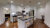Located on Locust Street in the heart of Center City Philadelphia, this single-floor residence offers a thoughtfully designed living space with modern finishes throughout. The kitchen serves as a standout feature, showcasing crisp white shaker-style cabinetry that extends to the ceiling, paired with striking dark granite countertops for a bold contrast. A central island with seating for multiple guests anchors the space, making it ideal for both casual dining and entertaining. Industrial-style pendant lights hang above the island, adding a warm, refined character to the room. The kitchen is fully equipped with a suite of stainless steel appliances, including a gas range, built-in microwave, refrigerator, and dishwasher. A classic subway tile backsplash adds texture and a timeless aesthetic to the cooking area. Rich hardwood flooring flows throughout, grounding the space with warmth and continuity. Recessed lighting ensures the interior is well-lit, complementing the clean, contemporary design. Situated in one of Philadelphia's most walkable and vibrant neighborhoods, this residence places residents steps from premier dining, shopping, and cultural destinations.