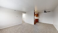 Located at 5179 Dempster Dr in Columbus, Ohio, this single-floor, 2-bedroom, 1-bathroom residence offers a practical and well-organized layout. The open living area features neutral-toned carpet and connects seamlessly to the kitchen, which is outfitted in a galley-style configuration with rich warm-toned cabinetry, light countertops, a double-basin sink, and black appliances including a range and refrigerator. A ceiling fan with a built-in light fixture overhead adds both comfort and functionality to the living space, which is finished with textured ceilings throughout.

The primary bedroom is a generously sized room with plush carpet, neutral walls, and natural light from a window with blinds. The second bedroom also features carpet flooring, a window, and a closet with sliding doors, providing ample storage. A hallway connects the bedrooms and leads to the shared bathroom, which features wood-look flooring, a white vanity with cabinet storage, a framed mirror with modern lighting fixtures, and a tub-shower combination. A dedicated closet in the hallway adds additional storage convenience. Overall, the space maintains a clean, neutral palette throughout, creating a versatile and move-in-ready environment.