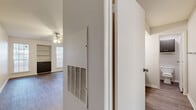 This 1-bedroom, 1-bathroom unit in Austin, TX offers a practical and comfortable single-floor layout. The living room is a bright, open space featuring rich hardwood-style flooring, a ceiling fan with light fixture, built-in shelving for display or storage, and a pass-through window connecting to the kitchen. Natural light flows in through multiple windows with blinds, and a sliding glass door leads to an outdoor area. The kitchen is efficiently designed with dark cabinetry, light speckled countertops, a stainless steel sink, a dishwasher, and a refrigerator, with textured walls adding character. The bedroom offers a comfortable footprint with a ceiling fan, a large window for natural light, and a mirrored sliding-door closet that enhances the sense of space. Two closets provide ample storage throughout the unit. The bathroom features a vanity with dark cabinetry and light countertop, with a separate water closet for added privacy. Hardwood-style flooring flows consistently throughout the unit, complemented by clean white walls and white baseboards, creating a cohesive, neutral aesthetic well-suited for a variety of furnishing styles.