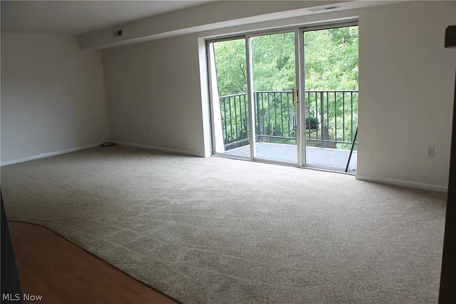 Living room window facing a small park with wooded views - 1900 King James Pky