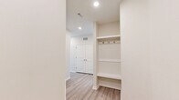 Located at 2819 Dixie Ave in Savannah, GA, this well-designed single-story home offers three bedrooms and three bathrooms with a cohesive modern aesthetic throughout. Light wood-look flooring runs through the main living areas, creating a bright and airy feel that complements the neutral color palette.

The kitchen is a standout feature, showcasing light wood cabinetry, a herringbone tile backsplash, quartz countertops, and a large center island with an undermount sink and pendant lighting. Stainless steel appliances, including a refrigerator, range, and over-the-range microwave, complete the space. A built-in desk nook adds functional versatility.

The bedrooms are carpeted for comfort, with ceiling fans and windows that invite natural light. The primary bedroom offers a generous footprint with access to a well-organized walk-in closet featuring wire shelving systems. Additional closet storage is available elsewhere in the home.

The bathrooms are elegantly finished with marble-look tile, wood-toned vanities, quartz countertops, and brushed gold fixtures. One bathroom features a glass-enclosed walk-in shower with full marble-style tile surround, while another includes a soaking tub. A built-in mudroom nook with open shelving and coat hooks provides practical entryway storage, rounding out this thoughtfully designed home.