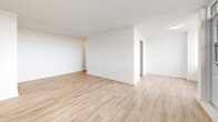 Located on the 8th floor at 3390 Keele St in Toronto's Downsview neighbourhood, this two-bedroom, one-bathroom unit offers a clean, modern living environment with a well-considered layout. Light-toned hardwood flooring runs consistently throughout, complementing the crisp white walls and creating a bright, cohesive aesthetic across all rooms. The open living area is generously proportioned, with large windows and direct access to a private balcony that frames expansive outdoor views of the surrounding landscape. The galley-style kitchen is efficiently designed, featuring white cabinetry, subway tile backsplash, dark countertops, stainless steel appliances including a full-size refrigerator, and a window that brings in natural light. Both bedrooms are well-sized and filled with natural light; the primary bedroom offers a large window with scenic treetop views, while the second bedroom includes dual closet doors for added storage. The full bathroom is finished with white subway tile surrounding the soaker tub, a white vanity with integrated sink, and neutral floor tile. A hallway connects the rooms, providing a practical and organized flow throughout the unit.