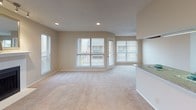 Located at 802 Broadway Commons in Garland, TX, this single-story unit offers a well-organized layout designed for comfortable everyday living. The spacious living room serves as the heart of the home, featuring plush carpeting, recessed lighting, a textured ceiling, and a classic fireplace flanked by a decorative mirror. Large windows and a sliding glass door flood the space with natural light and provide direct access to a private balcony with outdoor views. Track lighting adds a modern touch to this inviting area.

The kitchen is efficiently arranged with warm wood cabinetry, granite-style countertops, hardwood-style flooring, and white appliances including a refrigerator and dishwasher. A skylight brightens the space, and a pass-through opening connects the kitchen to the adjacent living and dining areas, enhancing the open feel of the layout.

The bedrooms are carpeted and well-proportioned, each equipped with a ceiling fan with light fixture and window treatments for natural light and privacy. Closet space is provided with sliding-door closets offering ample storage.

The bathroom is neatly appointed with a granite-topped vanity, a vessel sink, wood cabinetry for storage, and hardwood-style flooring, completing this functional and comfortable home.