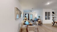 Located at 112 Hera Way in Myrtle Beach, SC, this well-appointed 2-bedroom, 2-bathroom residence offers a thoughtfully designed single-floor layout that balances comfort and modern style. Light wood-style flooring flows consistently throughout the space, complementing the clean white walls and creating a bright, cohesive aesthetic.

The open-concept living and dining area serves as the heart of the home, featuring a ceiling fan and generous natural light from large windows and a glass door. The kitchen is a standout feature, boasting crisp white shaker cabinetry, granite countertops, a large island with bar seating, pendant lighting, stainless steel appliances, and a classic white tile backsplash — ideal for both everyday cooking and entertaining.

The primary bedroom is a comfortable retreat with a ceiling fan, direct access to its en-suite bathroom, and a spacious walk-in closet equipped with wire shelving and hanging rods. The en-suite bathroom features granite countertops and an undermount sink with brushed nickel fixtures. The second bedroom is equally well-sized with its own bathroom access. A dedicated closet adds further storage convenience. Throughout the home, the neutral palette and clean finishes create a modern, move-in-ready atmosphere.