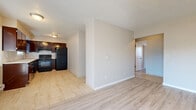 Located at 4333 NE 133rd Ave in Portland, Oregon, this two-bedroom, one-bathroom unit offers a practical and well-organized single-floor layout. Light wood-style flooring flows throughout the living areas and bedrooms, creating a clean and cohesive aesthetic, while large-format tile flooring is featured in the kitchen and bathroom.

The open living room is bright and inviting, highlighted by a sliding glass door that allows natural light to fill the space and provides a view to the outdoors. A baseboard heating unit ensures year-round comfort. The living room connects seamlessly to the kitchen, which is equipped with dark espresso-toned cabinetry, a tile backsplash, and a full suite of black appliances including a refrigerator, range, and dishwasher.

The primary bedroom is generously sized and features two closets, offering ample storage. The second bedroom is a comfortable and flexible space. A central hallway with textured walls connects the bedrooms to the full bathroom, which includes a dark wood vanity, a tiled soaking tub and shower surround, and large-format tile flooring. The textured ceilings throughout add a classic residential character to this efficiently designed Portland home.