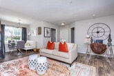 Located at 2800 Herrington Woods Ct in Lawrenceville, Georgia, this single-floor residence offers a thoughtfully designed layout that balances comfort and functionality throughout. Rich wood-look flooring flows through the main living areas, creating a warm and cohesive aesthetic.

The living room is an inviting, open space anchored by neutral walls and generous natural light. It connects seamlessly to a dedicated workspace nook, making the layout highly versatile. The kitchen features crisp white cabinetry with brushed hardware, dark countertops, a subway tile backsplash, and a full suite of stainless steel appliances including a gas range, microwave, and refrigerator. A peninsula provides additional prep space and casual seating.

The primary bedroom is a serene retreat, offering plush carpeting, ample natural light through draped windows, and access to a spacious walk-in closet outfitted with extensive wire shelving for organized storage. The en-suite bathroom includes a white vanity, wood-look flooring, and a full tub and shower combination. A second bedroom features carpeted floors, a standard closet with rod and shelf, and a similarly calm, neutral palette. The second bathroom mirrors the clean, modern finishes found throughout, with a white vanity and wood-look tile flooring. This well-maintained residence offers a practical and comfortable living environment in a convenient Lawrenceville location.