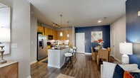 Located at 4100 Southwest Fwy in Houston, TX, this thoughtfully designed two-bedroom, two-bathroom residence offers a comfortable and stylish single-floor layout. The open living and dining area makes a striking first impression with bold navy accent walls, warm wood-style flooring, and large windows that invite natural light. The kitchen is efficiently laid out with light maple cabinetry extending to the ceiling, dark granite-style countertops, a white subway tile backsplash, and black stainless appliances, offering both style and functionality. The dining area flows naturally from the kitchen and living room, creating a cohesive space ideal for entertaining. The primary bedroom is a serene retreat with plush carpet, soft neutral tones, and generous proportions, complemented by a spacious walk-in closet featuring wire shelving and basket storage. The second bedroom benefits from a large window with outdoor views and a ceiling fan. Both bathrooms are finished with slate-style tile flooring, warm wood vanities, dark countertops, and tub-shower combinations. The overall ambiance is modern yet warm, with consistent design elements tying each room together seamlessly throughout the residence.